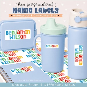 May include: A collection of personalized name labels featuring the text Benjamin Wilson in colorful, rounded letters. The labels are applied to a light blue lunch box, a light blue sippy cup, a light blue water bottle, and a spiral-bound notebook.
