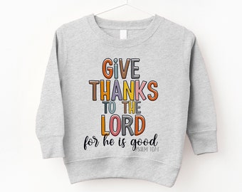 May include: A gray sweatshirt with the text "GIVE THANKS TO THE LORD for he is good PSALM 107:1" in colorful letters.