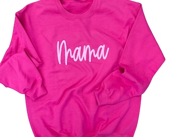 May include: A pink sweatshirt with the word "Mama" written in white on the front.