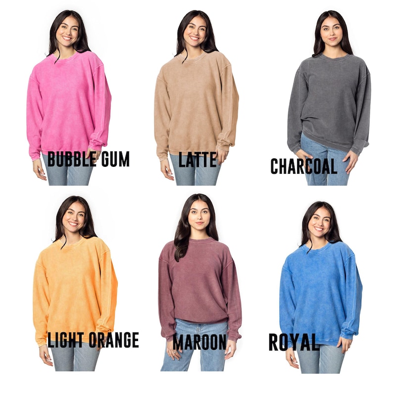 May include: Six women are wearing different colored sweatshirts. The colors are bubble gum pink, latte, charcoal, light orange, maroon, and royal blue. The sweatshirts are all the same style, with a crew neck and long sleeves.
