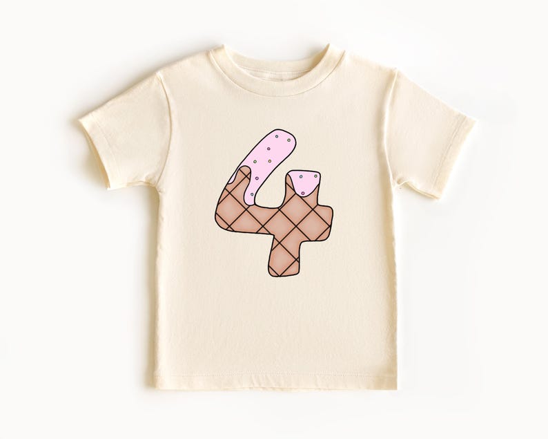 May include: A white t-shirt with a brown and pink ice cream cone shaped number four on the front.