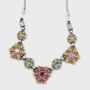 May include: Silver-tone necklace featuring a floral design with orange, yellow, pink, and green enamel accents. The necklace has a series of flower-shaped pendants connected by a chain. The central pendant is a larger flower with a red center stone.