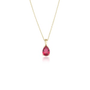 May include: A gold chain necklace with a pear-shaped red gemstone pendant.