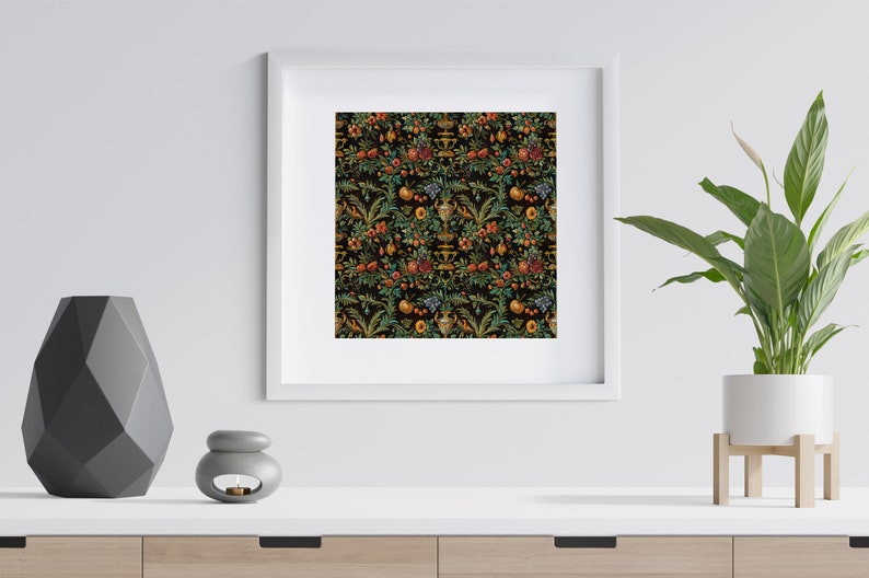 May include: A framed print of a black and gold floral pattern with a repeating design of fruit, leaves, and vases. The print is framed in a white frame and is hanging on a white wall.