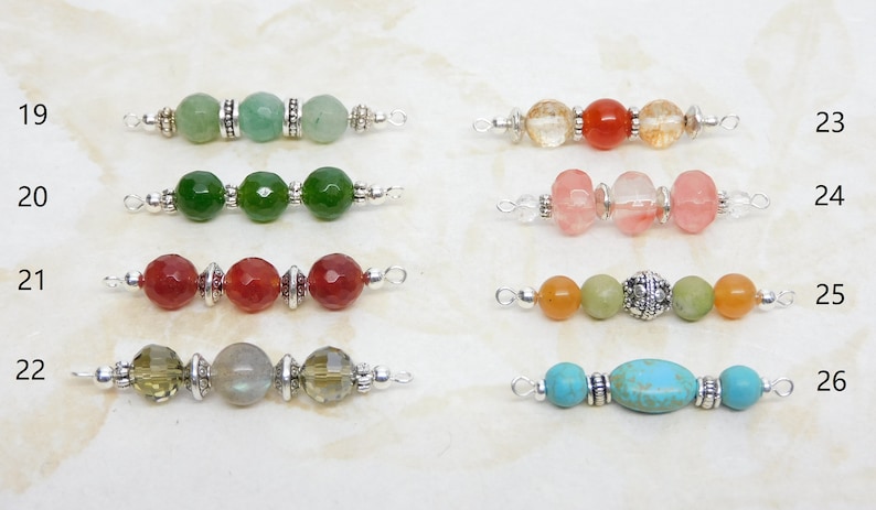 May include: A collection of beaded jewelry components, each featuring a unique combination of colorful gemstones and silver-toned metal accents. The beads vary in shape and color, including green, red, orange, and turquoise, offering a diverse range of design options.