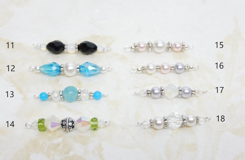May include: A collection of beaded jewelry components, each featuring a unique design. The components include various colors of beads, including black, blue, pink, and clear, with silver-toned metal accents. These components are ideal for creating custom jewelry pieces.