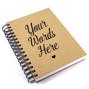 May include: A brown spiral bound notebook with the text "Your Words Here" printed on the front cover. A small black heart is printed below the text.