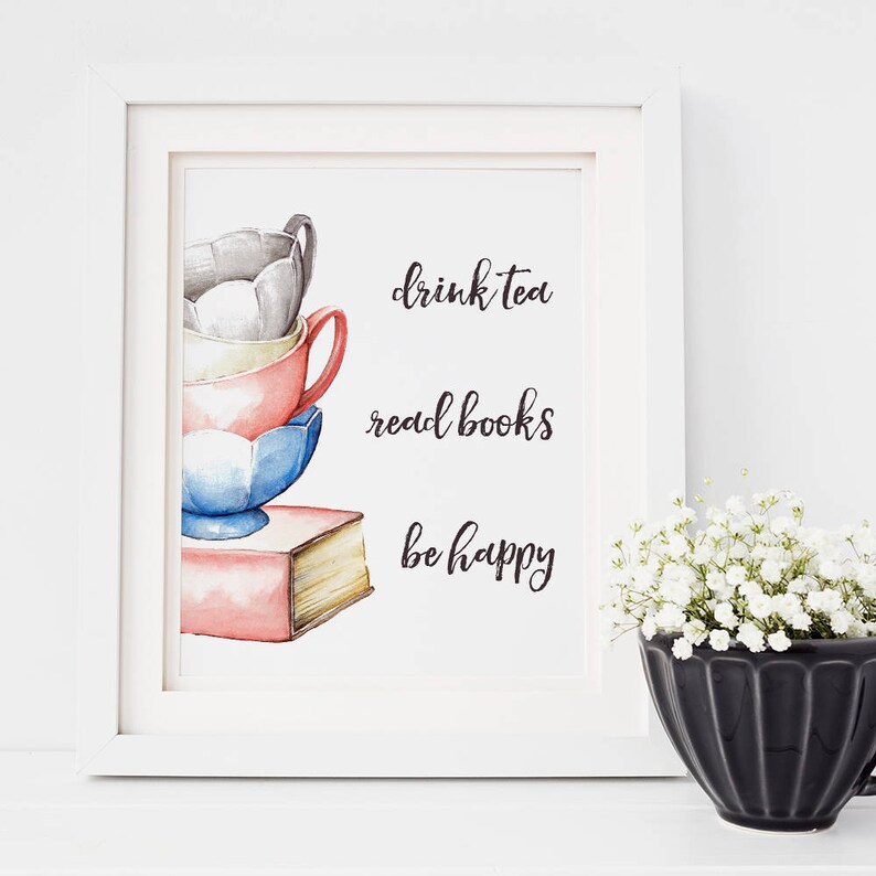 May include: A watercolor illustration of a stack of teacups and a book with the text "drink tea read books be happy".