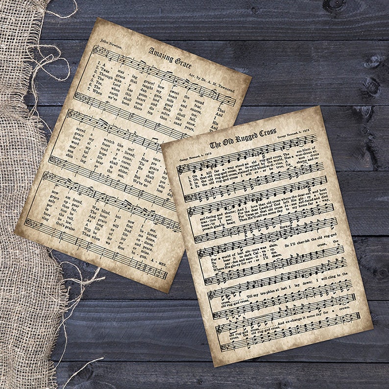 May include: Two vintage sheet music pages with the lyrics to the hymns "Amazing Grace" and "The Old Rugged Cross". The pages are yellowed and have a distressed look, giving them a vintage feel.