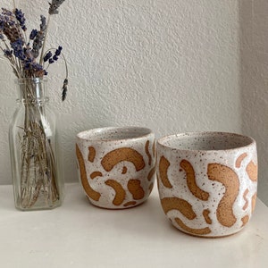 speckled white abstract squiggles cup