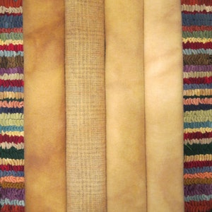 May include: Five pieces of fabric in various shades of beige and brown, stacked on top of each other. The fabric is a soft, natural material with a slightly textured surface.