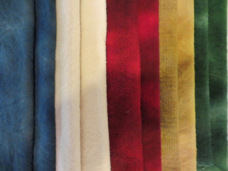 May include: A collection of eight fabric swatches in various colours, including blue, white, red, yellow, and green. The fabric swatches are arranged in a row, with the blue swatches on the left and the green swatches on the right.