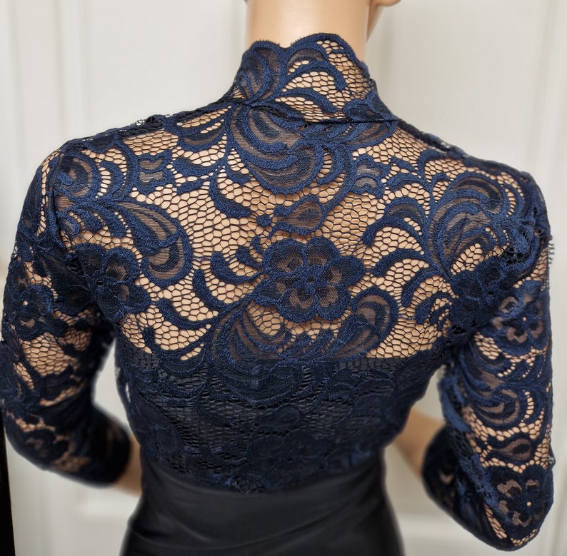 Lace bolero with a slight stretch in a two tone Black and Navy with 3/4 sleeves , Scalloped neckline and down the fronts . Ideal for a special occasion