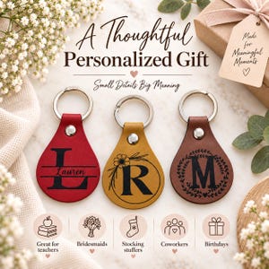 May include: Three teardrop-shaped leather keychains in red, yellow, and brown, each featuring a silver metal ring and a personalized black monogram or name. The red keychain displays the name Lauren, the yellow features an R, and the brown has an M.
