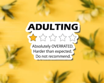 May include: A sticker with a humorous review of "adulting" with a one-star rating. The text reads "Absolutely OVERRATED. Harder than expected. Do not recommend."