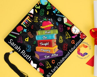 May include: Black graduation cap with a chalkboard design featuring colorful letters, a stack of books with the text "And She Taught Happily Ever After", and a red apple with the text "Class of 2024". The cap has a black tassel and the text "Sarah Ruth" and "B.S. Early Childhood Education" are printed on the cap. The text "Colorful Co. Stationery and Gifts" is printed on the bottom right corner of the cap.