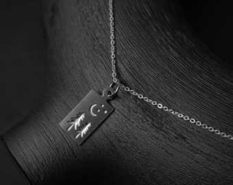 Moonlit Forest Necklace: Our tiny pendant necklace features a moon and stars above evergreen trees, rectangular silver layering necklace