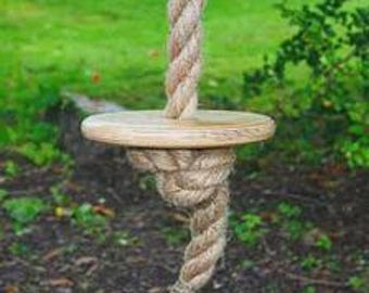 Tree swing with disc seat and thick rope for good grasp