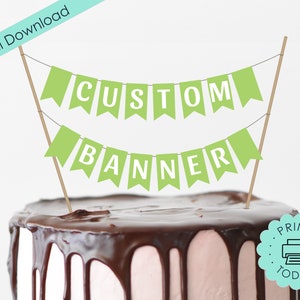 May include: Green and white printable banner that says "CUSTOM BANNER" on a cake topper. The cake is frosted with chocolate icing. The text "PRINT TODAY!" is on a teal circle with a printer icon.