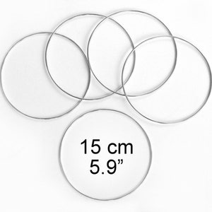 May include: Five silver metal hoops, each measuring 5.9 inches in diameter.