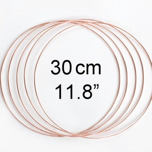 May include: Five copper wire hoops, each measuring 11.8 inches in diameter. The hoops are stacked on top of each other.