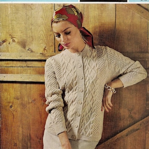 May include: A woman wearing a beige cable knit cardigan with buttons and a red headscarf. The cardigan is made of double knitting wool and double crepe wool. The pattern is called "Sirdar 2209B" and costs 9d.