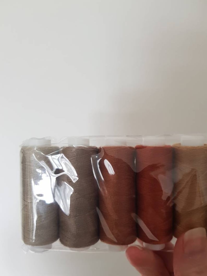 9 spools of polyester thread in different shades of brown