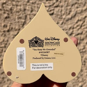 May include: A white ceramic mug with a black handle and the text "But First, Coffee" in a bold, black font. The mug is set against a neutral background, highlighting its simple design.