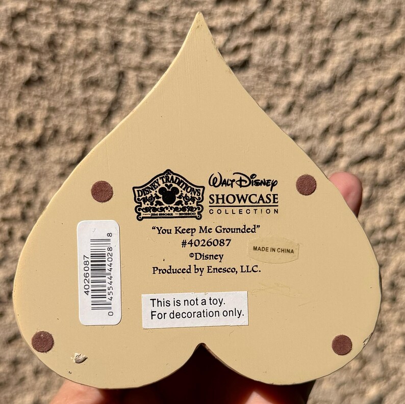 May include: A white ceramic mug with a black handle and the text "But First, Coffee" in a bold, black font. The mug is set against a neutral background, highlighting its simple design.