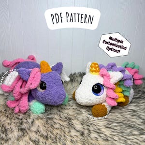 May include: Two plush unicorn toys, one purple and one white, with colourful manes and horns. The unicorns have large, expressive eyes and are lying on a fluffy, grey surface. The image includes text that says "PDF PATTERN" and "Multiple Customization Options!"