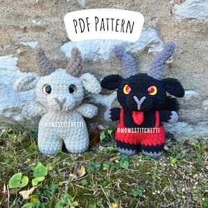 May include: Two crocheted goat amigurumi toys. One is gray with brown horns and the other is black with red horns and a red bib. The toys are sitting on a bed of green grass in front of a stone wall. The text "PDF PATTERN" is written in white on a black background above the toys. The text "@MOMSSTITCHETTI" is written below each toy.