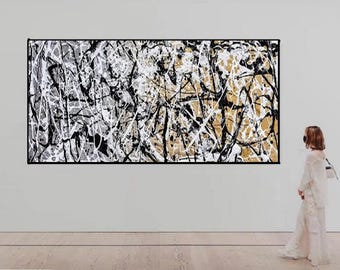 May include: A large rectangular wall art piece featuring an abstract composition of chaotic, overlapping black and white paint splatters and drips layered over a textured gold background, creating a dense, energetic, and complex visual pattern.