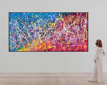 May include: A large rectangular abstract painting featuring a vibrant drip-style composition. The artwork displays a chaotic network of splattered paint in bright shades of blue, magenta, yellow, white, and purple across the entire canvas surface.