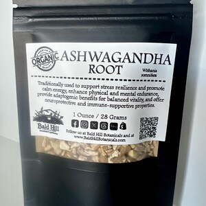 May include: A black pouch of organic Ashwagandha root. The label reads "Organic Ashwagandha Root" and lists the benefits. The pouch contains 28 grams of the product. The brand name is Bald Hill Botanicals.