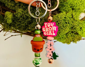 Motivational and cute keychains with plants,succulents,cherry blossom flowers in silver & rose gold. Gift for all- soft silicone beads.