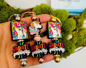 Bold and vibrant rainbow unicorn keychains with positive message, good vibes and radiate positivity! Cute and colorful accessories.