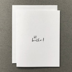 May include: A white card with the text "WHY hello!" written in black cursive.