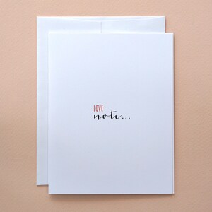 May include: A white card with a red "LOVE" and black cursive text that reads "not..."