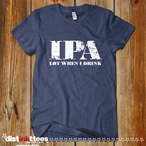 May include: A navy blue t-shirt with a white distressed graphic that reads "IPA LOT WHEN I DRINK".