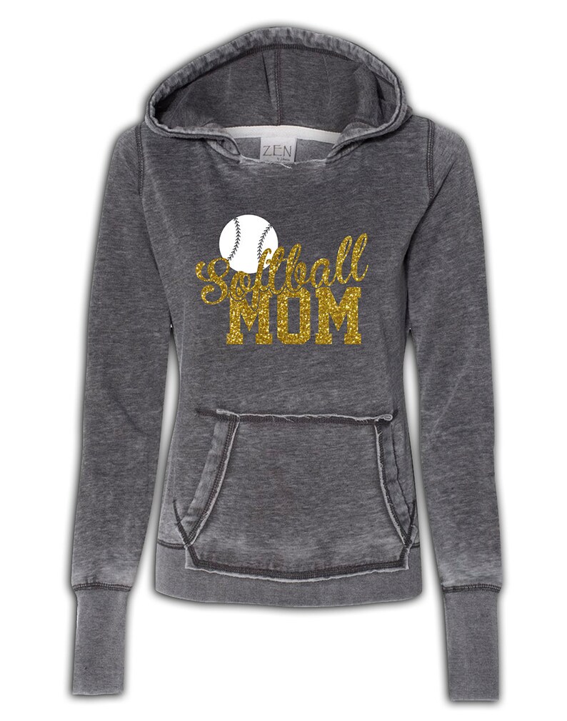 May include: A gray hooded sweatshirt with a distressed look. The sweatshirt has a large gold glitter graphic that says "Softball Mom" with a white softball graphic above the text.