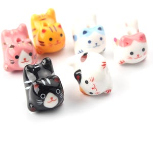 May include: Six ceramic cat chopstick rests, each with a different colour and pattern. The cats are in various poses, including lying down, sitting up, and curled up. The chopstick rests are a fun and decorative way to add a touch of whimsy to your dining table.