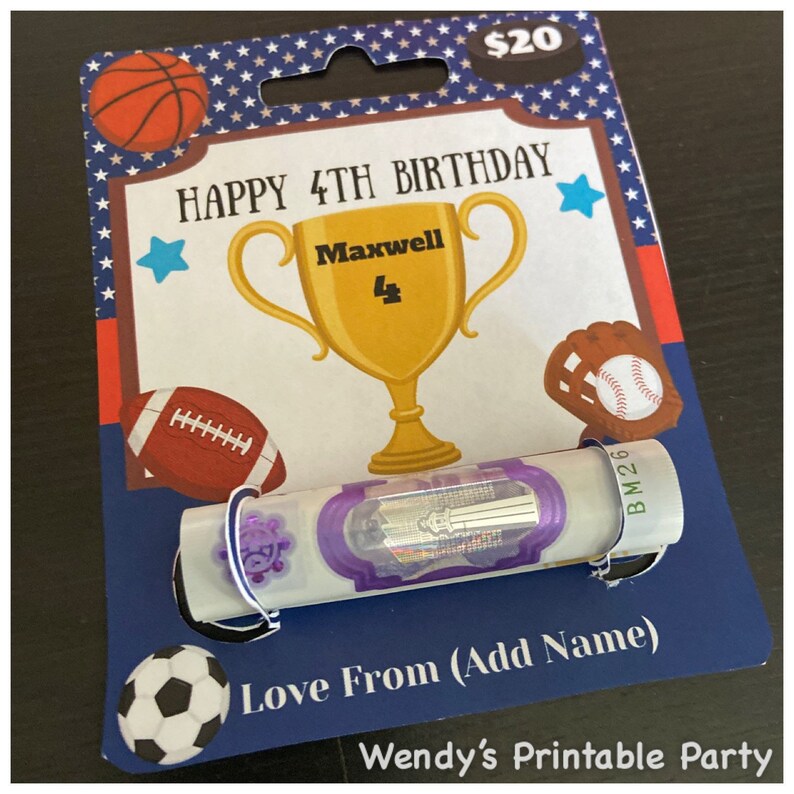 May include: A birthday gift card with a blue background, featuring a gold trophy, a football, a baseball, a basketball, and a soccer ball. The card reads "HAPPY 4TH BIRTHDAY" and "Love From (Add Name)". A $20 bill is attached.