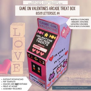 May include: Printable PDF template for a Valentine's Day arcade treat box. The box is pink and purple with a pixelated design. The text on the box says "Game On, Valentine" and "Valentine Arcade Treats". The box is 1.75 inches wide, 5 inches high, and 3 inches long.