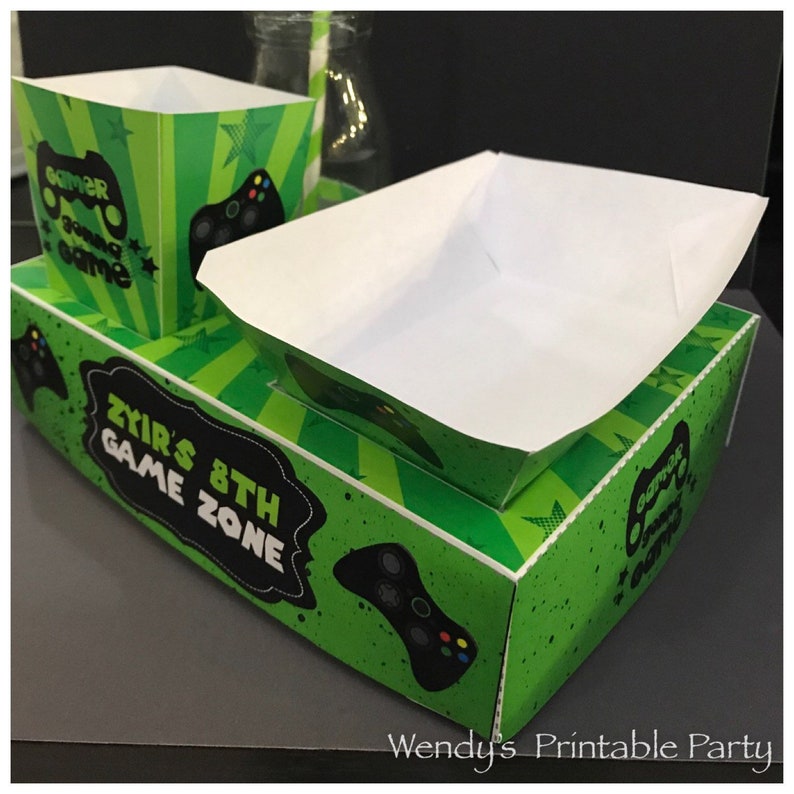 Gamer themed party lunch box with hotdog nacho tray and popcorn box with green background and controller images perfect for video game party or slumber party. Great snack box, concession food tray, PDF template. personalise with your birthday message