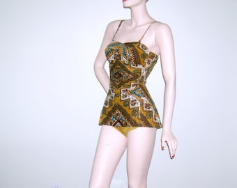 May include: A vintage swimsuit with a geometric pattern in shades of brown, green, and blue. The swimsuit has a fitted bodice and a full skirt.