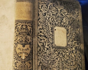 May include: A vintage book with a black and gold cover. The title "Ivanhoe" by Scott is printed on the spine. The book is part of the Aldine Edition.