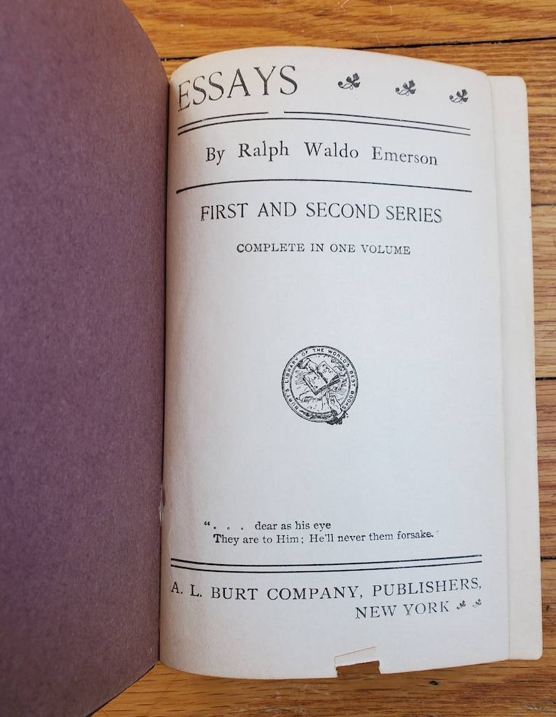 May include: A white book with the title "Essays" by Ralph Waldo Emerson. The book is a collection of essays from the first and second series, complete in one volume. The book is published by A. L. Burt Company in New York.