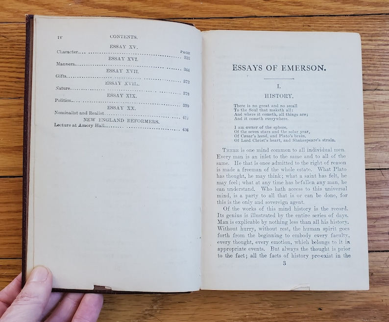 May include: An open book with a white background and black text. The book is titled "Essays of Emerson" and the first essay is titled "History". The text discusses the concept of a universal mind that is shared by all individuals.