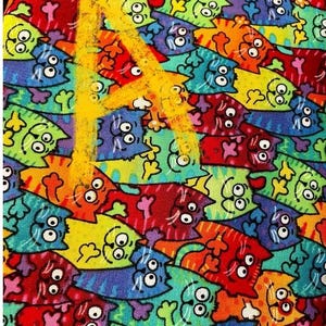 May include: A colorful fabric with a repeating pattern of cartoon cats. The cats are all different colors and have different expressions. The fabric is a great choice for a variety of projects, such as quilting, sewing, and crafts.