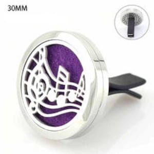 May include: Silver car air freshener with a musical note design and a purple felt pad. The air freshener is 30mm in diameter and has a clip to attach to a car vent.